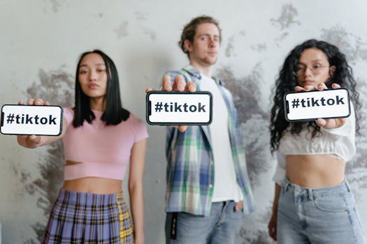 Group of young adults holding phones with #tiktok indoors, showcasing social media culture.