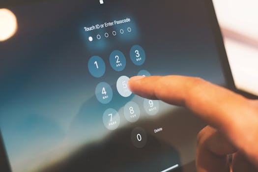 Close-up of a finger entering a passcode on a smartphone security screen.