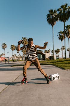 A man roller skating energetically in a sunlit park with palm trees and a boombox.